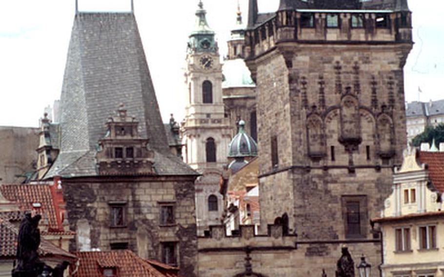 Prague’s 14th-century Charles Bridge, with the Mala Strana neighborhood in the background, attracts many admirers.