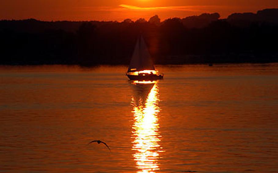 A sailboat heads to its dock as the sun sets on Chiemsee, Germany&#39;s largest lake. AFRC Chiemsee is closing on Sept. 2.