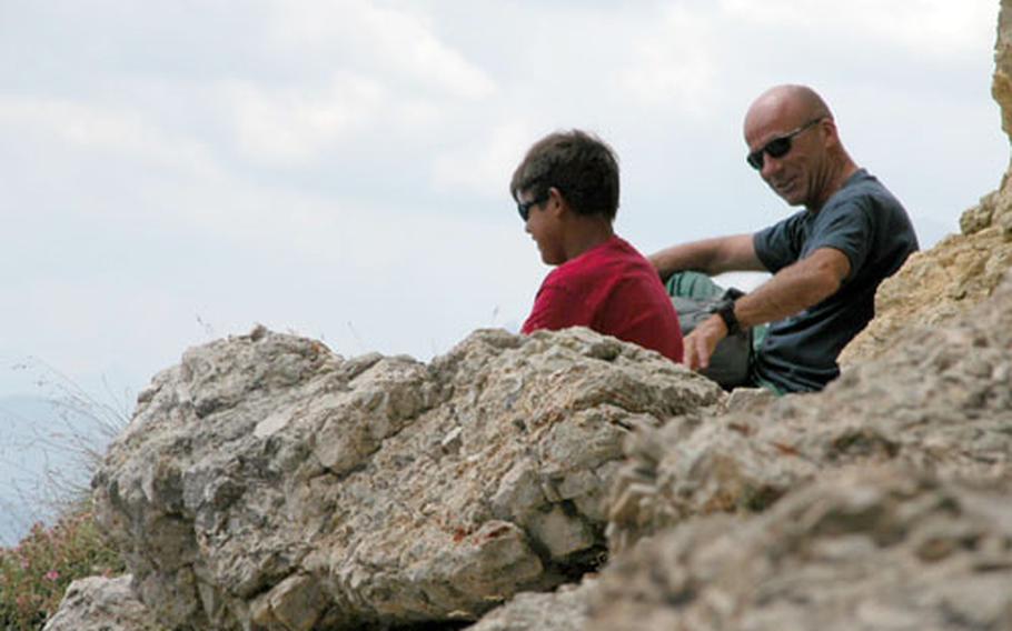 The cliffs of Passo Falzarego, near Cortina, northern Italy, are a great place to sit down for a father-son chat.