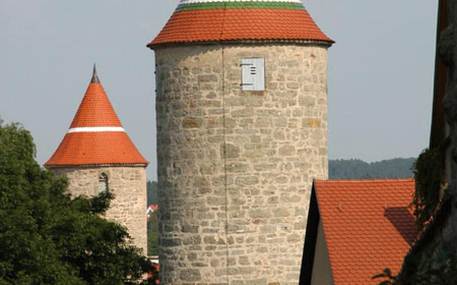 Two of Dinkelsbühl, Germany&#39;s 18 medieval towers, the Krugsturm and the Hertelsturm. Like Rothenburg, also on Germany&#39;s Romantic Road, Dinkelsbühl is surrounded by medieval fortifications. Unlike in Rothenburg however, you can&#39;t walk along the walls.