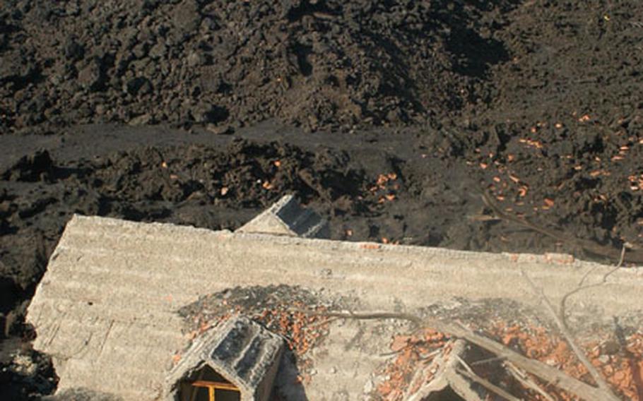 Evidence of the volcano’s devastation is shown in this two-story house, buried in lava up to its top windows.