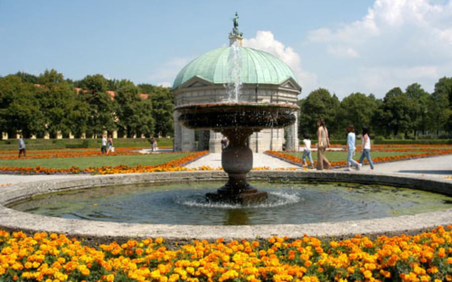 A fountain in the Hofgarten (Court Garden), with the 12-sided temple to Diana behind it.