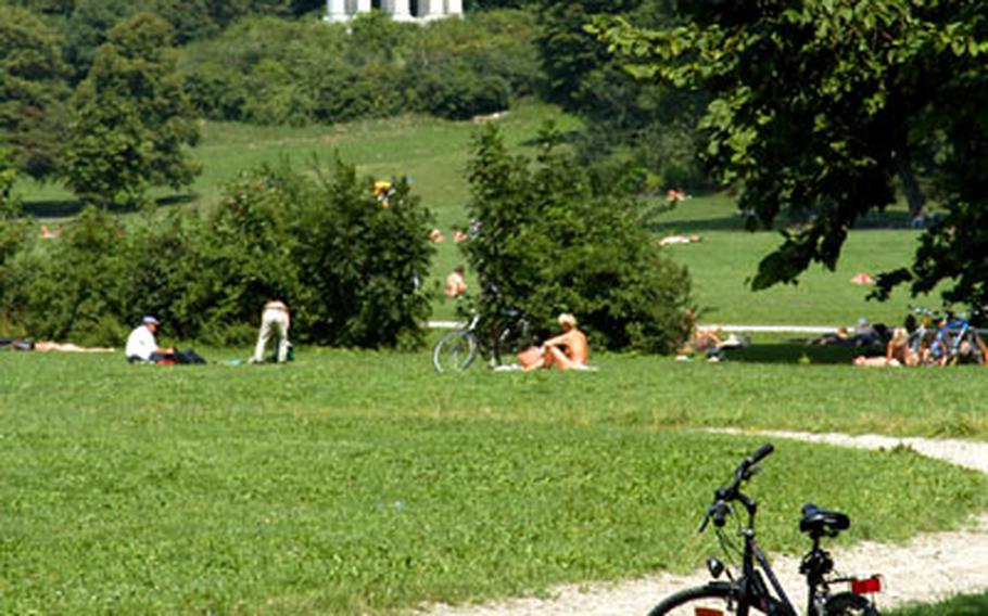Munich&#39;s English Garden is a popular outdoor spot. In the background is the Monopteros, from where there is a view over the park towards downtown.