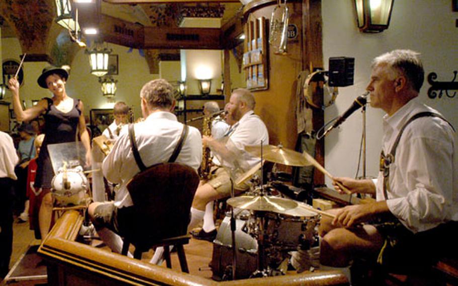 A tourist leads the Hofbrauhaus band through a German oom-pah-pah song on a typical night at Munich&#39;s famed beer hall.