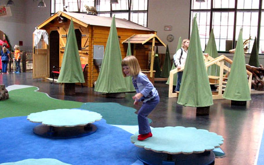 Caitlin Wesson jumps on the water lily pads in the “World of Rapunzel and Haensel-in-Boots” at the Kindermuseum Labyrinth.