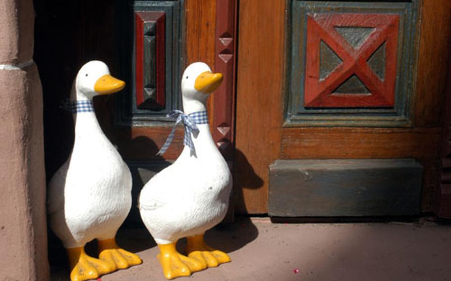 Painted wooden geese guard the entrance of a winemaker’s house.