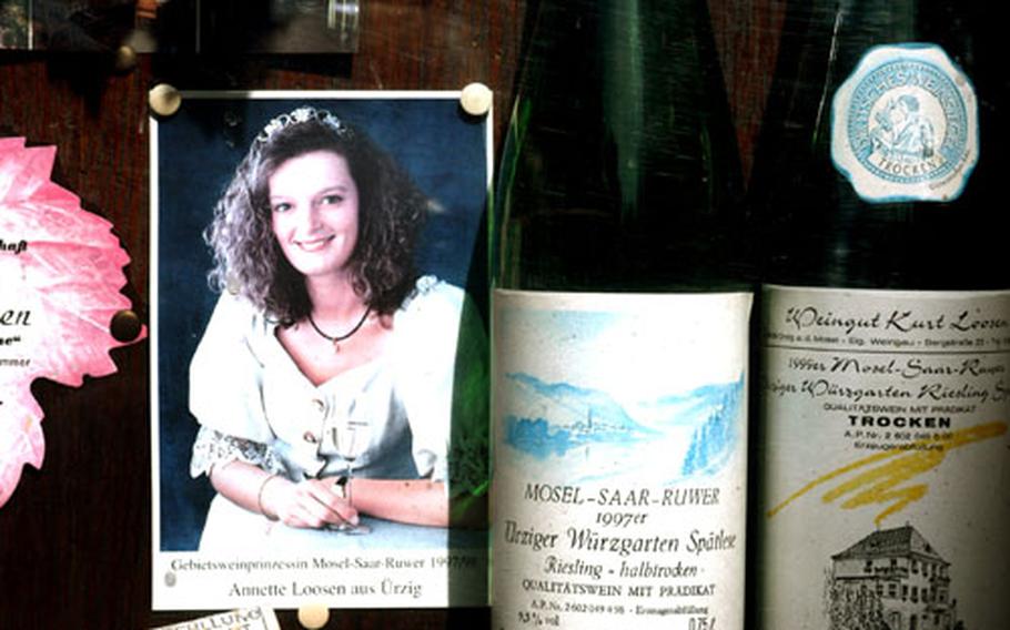 Kurt Loosen, a local winemaker, advertises his products in a glass box outside his house, Among the bottles is a portrait of daughter Annette, who was the district wine princess in 1997-98.