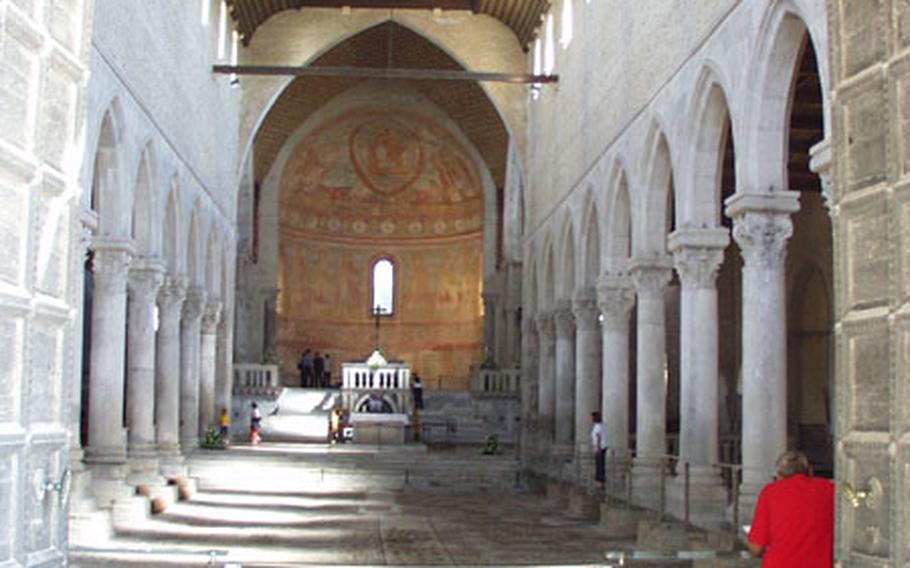 Visitors aren&#39;t allowed to take pictures of the mosaics and frescoes inside the Patriarchal Basilica in Aquileia, Italy. But, thanks to glass walkways, they can see most of the ancient artwork that graces the church.