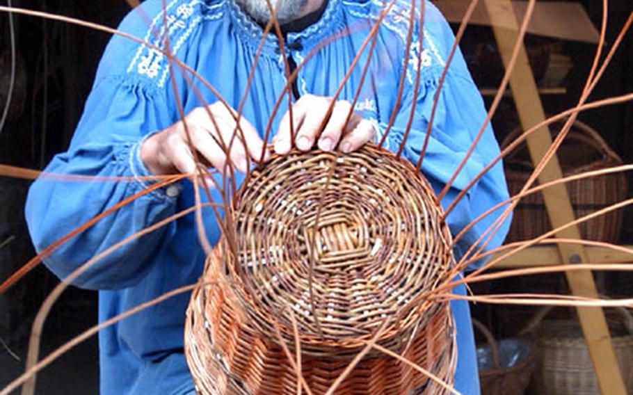 A basketmaker weaves at the Hessenpark. On weekends various craftsmen demonstrate how things were done in the old days.
