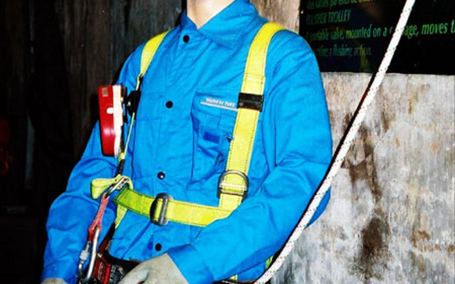 A mannequin shows the uniform and protective gear worn by those who work in the sewers beneath Paris.