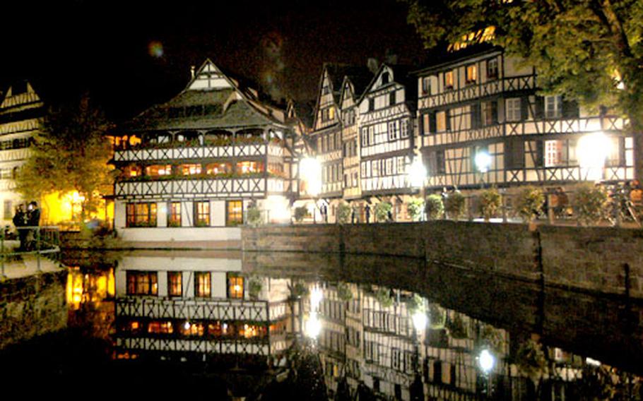The Petite France section of Strasbourg, with the Tanner&#39;s house at left, glows at night.