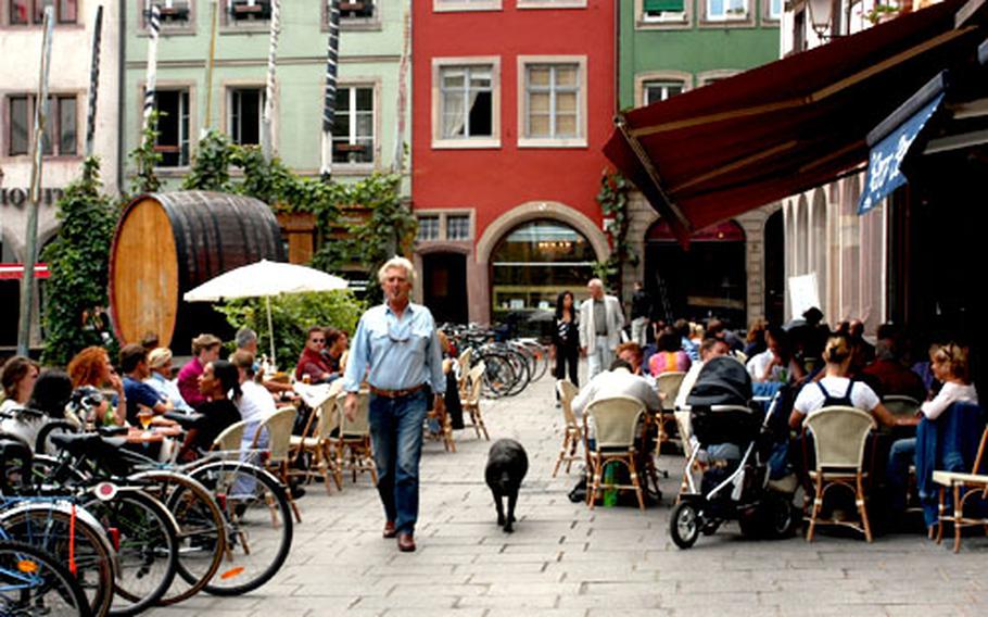 A typical Strasbourg street scene — people (and animals) enjoying cafés and promenades.