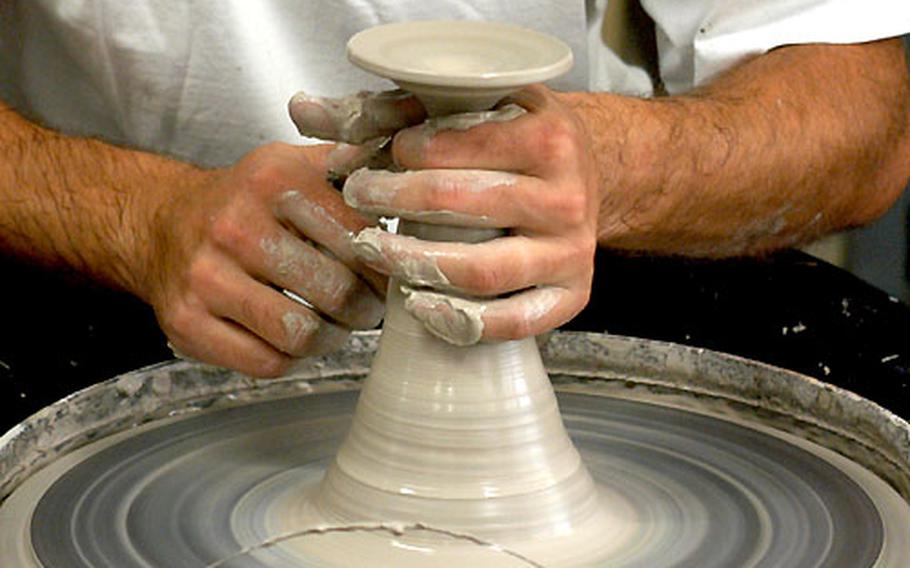A potter’s hands turn a lump of clay into a vase at a workshop in Soufflenheim.