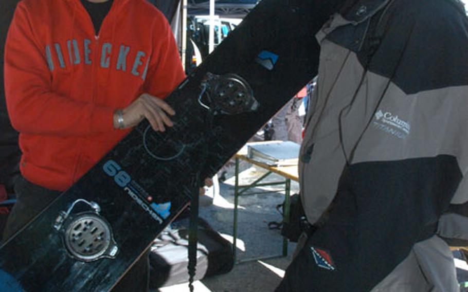 Nidecker salesman Sasha Ulpke offers Hank Dunn, 33, of Houston, Texas, a brand-new snowboard to test out on the Tiefenbach glacier above Sölden, Austria.