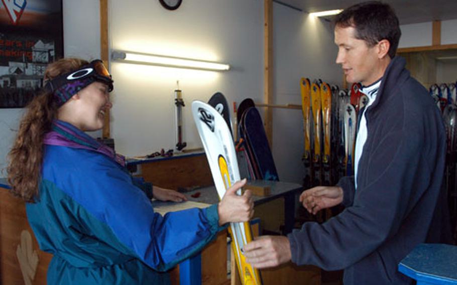 Air Force Staff Sgt. Heidi Lawson checks out a set of K2 skis from Siggi Klotz at the base of the Rettenbach glacier.