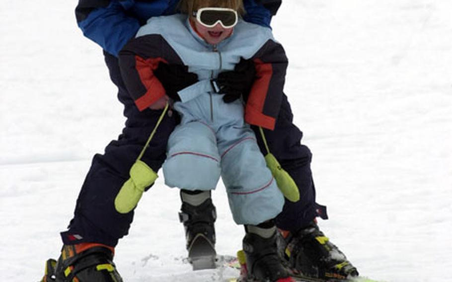 Heading down the slopes at AFRC Garmisch with a little help from daddy.