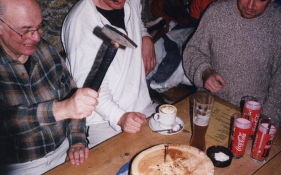 A popular hut game involves pounding nails into a log. The loser must buy a round of schnapps for the other players.