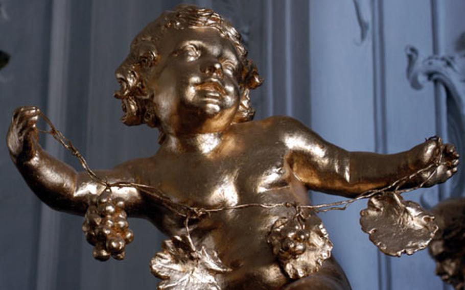 This putto decorating a stove in the White Hall of the Würzburg Residenz is the work of Materno Bossi.