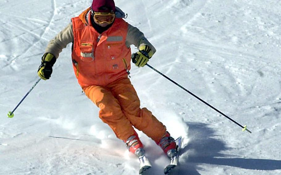 A skier tests the manmade snow on an early season run at Chonma Ski Lodge.