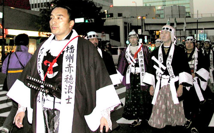 Former popular sumo wrestler Terao leads a group of men dressed as the 47 Ronin parading through a Tokyo Ginza Street last year.