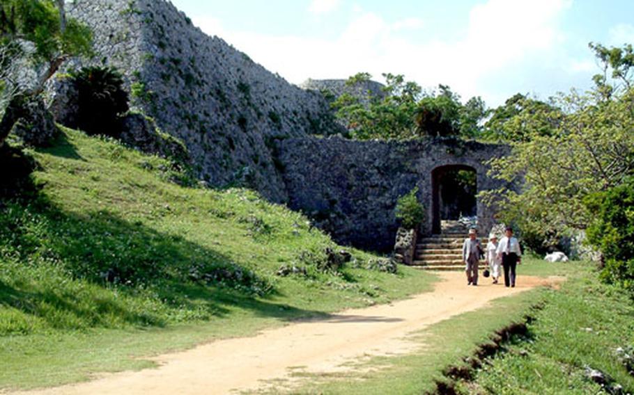 Tourists leave Nakagusuku Castle’s Arch Gate Way.