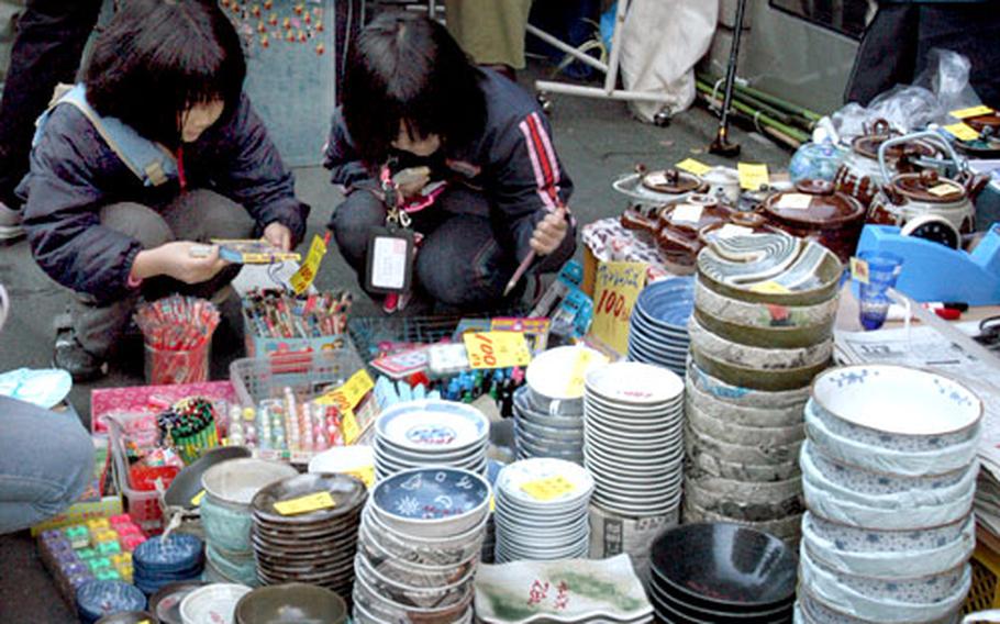 Girls look through stationery sold at Boro-ichi held in Tokyo, Dec. 15 and 16.