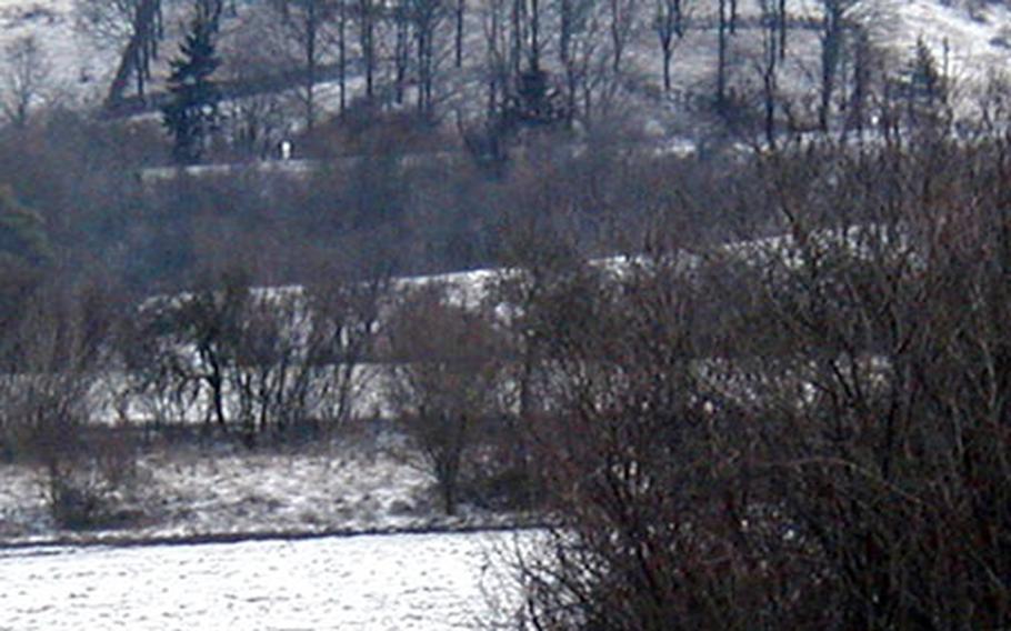 As a memorial to German soldiers killed in World War I, several veterans from the German village of Burgbernheim planted oak trees and bound them with vines to form this Maltese cross, a traditional Prussian military symbol. Eighty years later, it still stands, though it is hard to see without a blanket of snow on the hillside.