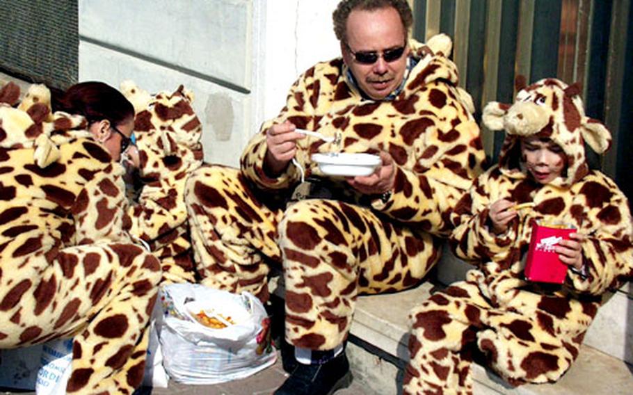 An observer at Viareggio's Carnevale would be hard pressed to find anyone under the age of 20 not wearing a costume. Many Italian families, such as this one taking a break for lunch, celebrate the event together.
