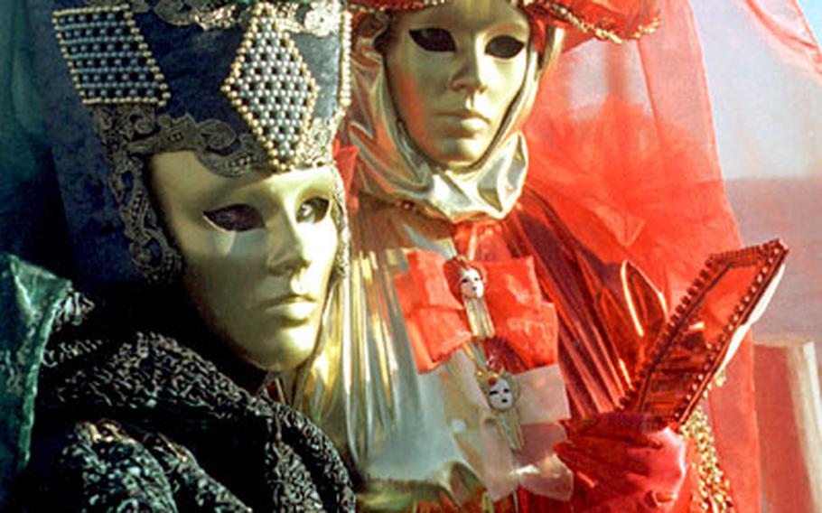 At Carnevale in Venice, mysterious creatures pose for photographers.