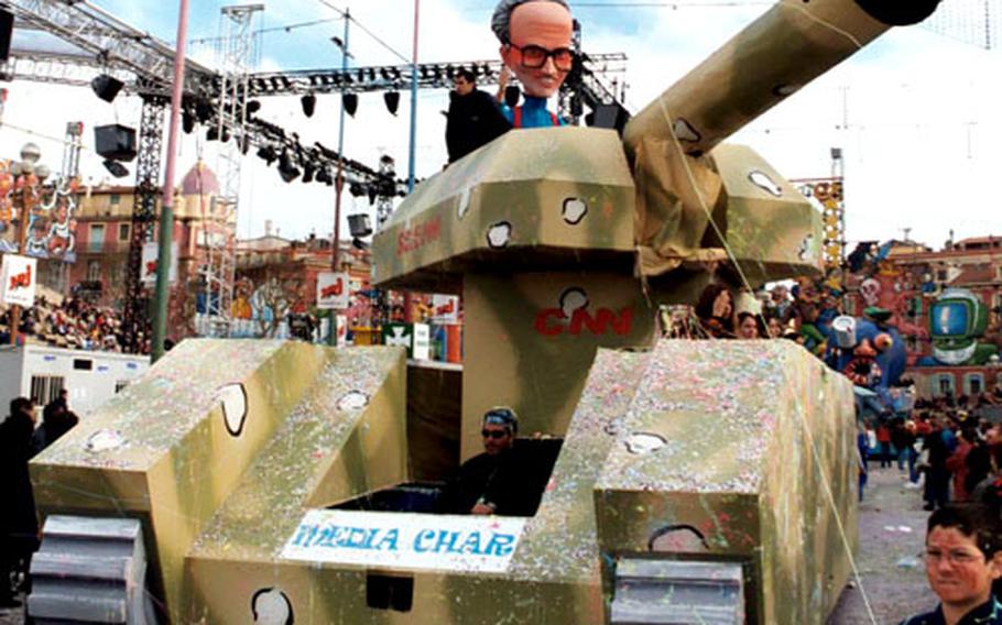 A tank driven by a papier-mâché Larry King blasts war news in the form of confetti out of its main gun during the parade at the 2003 Nice Carnival.