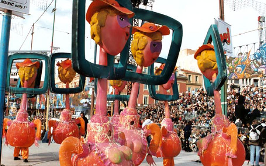 Television “talking heads” roam the streets of Nice, France, during Carnival celebrations last year. Political cartoonists from throughout the world submit sketches of floats to be considered, and local artists create the final products.