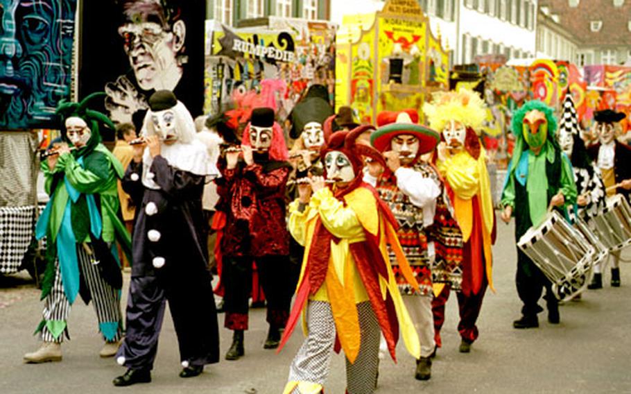 A local clique, or Fasnacht band, marches in front of the artistic lanterns at the Münster- platz in Basel, Switzerland.