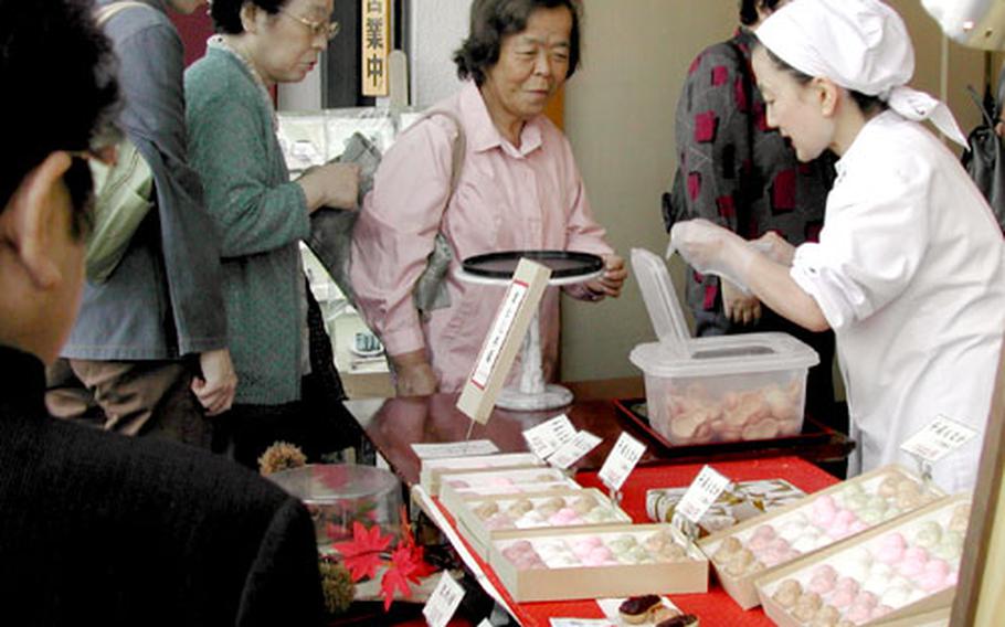 People buy traditional Japanese "monaka," bean jam-filled wafers, at Jizo Dori in Sugamo.