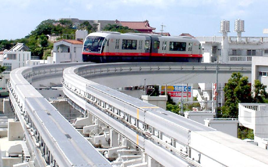 A Yui Rail double-car pulls into Shuri Station.