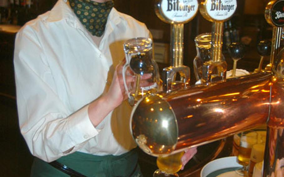 Gaby Sytkova prepares a tray of beer samples for visitors at Bitburg&#39;s Braustuebe following a Bitburger Brewery tour.