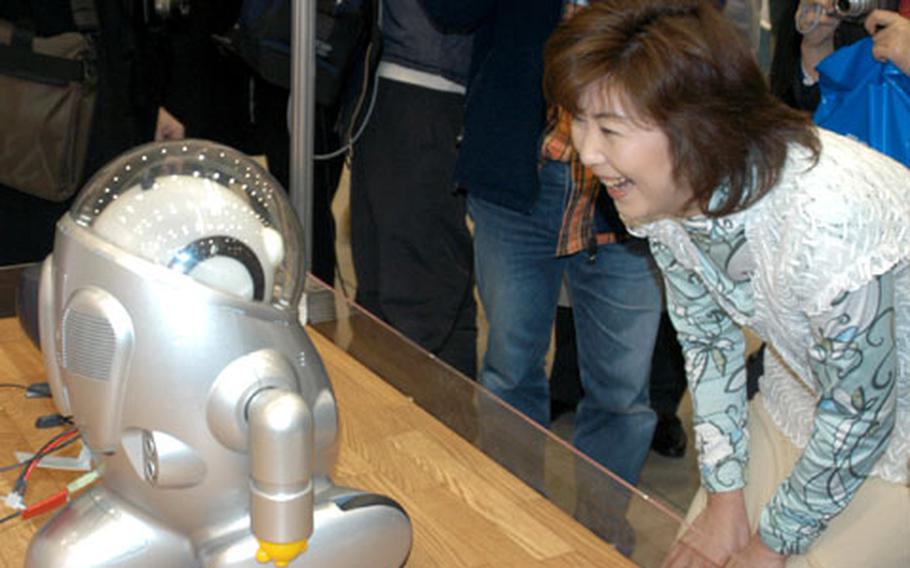 The entertainment robot Ifbot, talks to visitors at the International World Robot Trade Fair in Fukuoka last month.