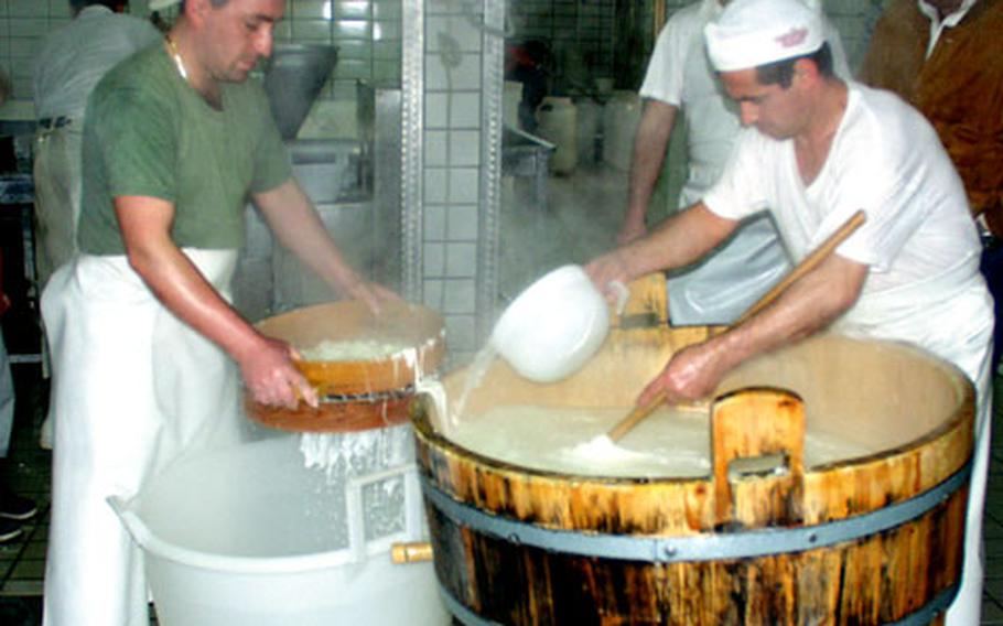 Steam rises as workers mix hot milky water with soft chunks of cheese. In a traditional spinning process, the worker stirs the batch by hand, scooping out the liquid, until the cheese becomes malleable enough to mold into smaller balls.