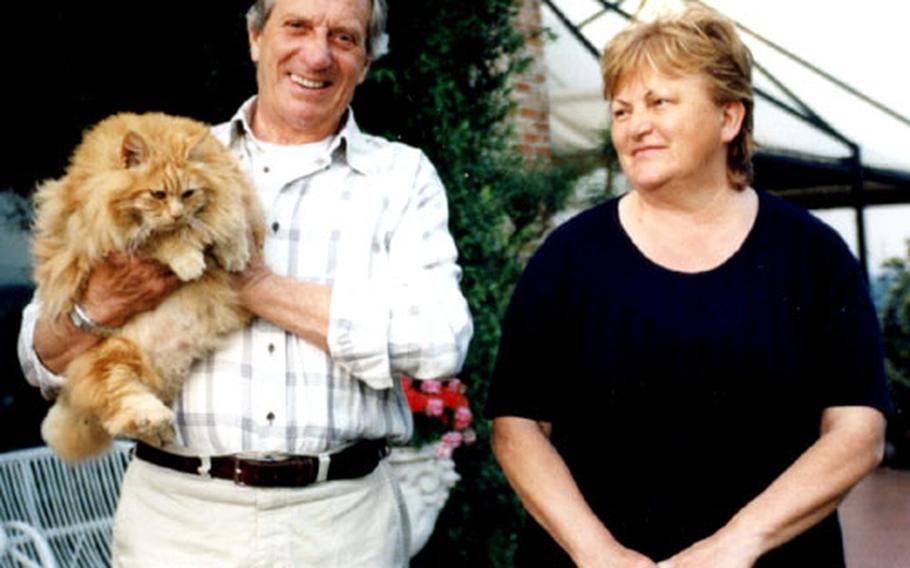 Franco and Ester Carnero with their cat, Pepito. They say Pepito is well-known to guests at their bed-and-breakfast inn — many arrive with pictures of the cat taken on previous visits.