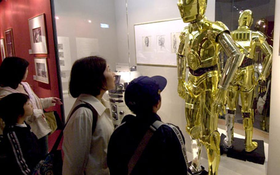 See many displays with costumes and models used in the movies and concept art.