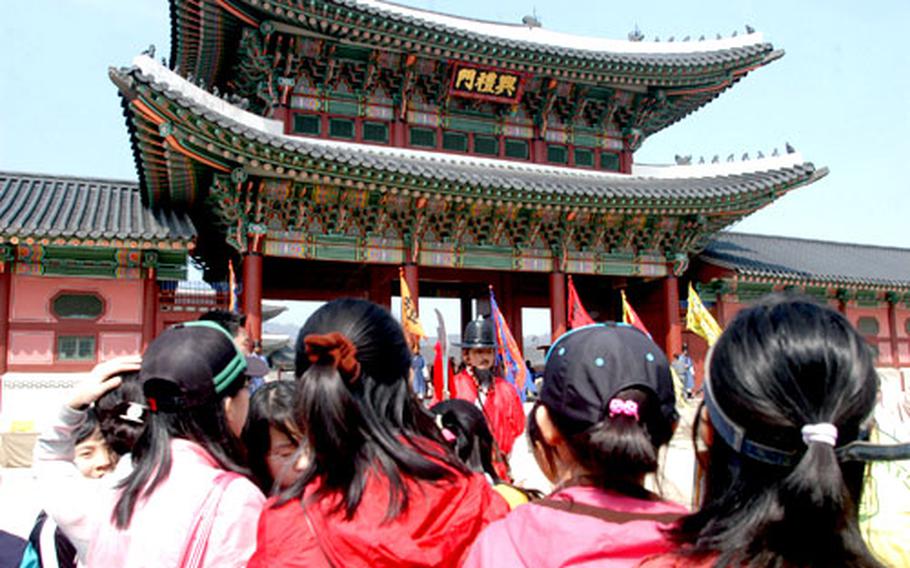 Schoolkids gaze at Heungnyemun, the second gate on the Gyeongbok Palace grounds.