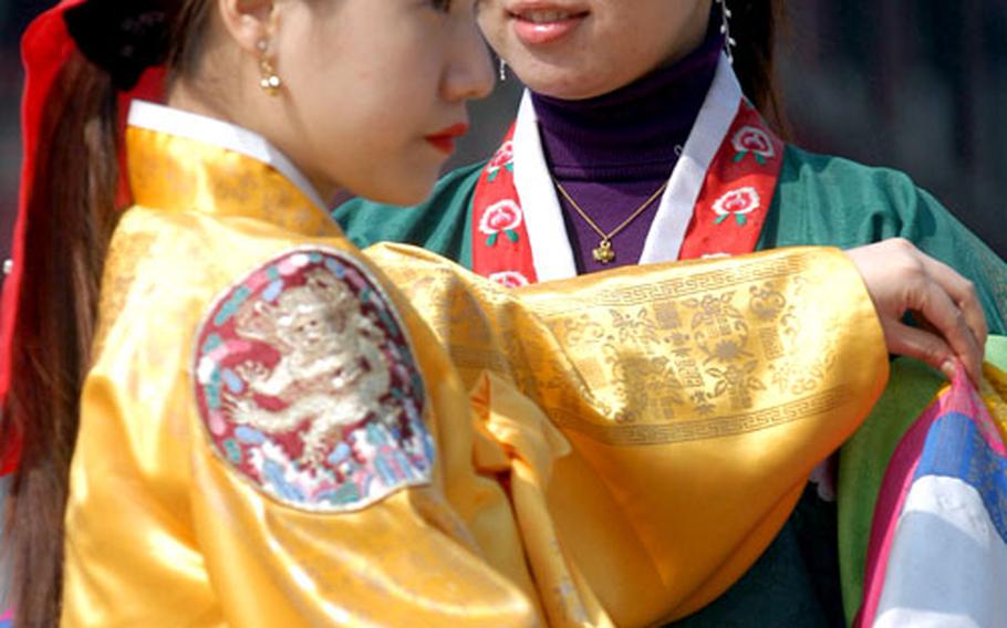 Traditional Korean dresses called hanboks are available on racks near Gyeonghoeru, a structure surrounded by a pond lined with trees, for those who’d like to dress up for a photograph.