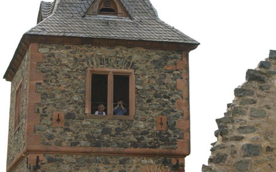 A couple peers out the tower at Burg Frankenstein. The tower offers a great view all the way to the Rhine River.