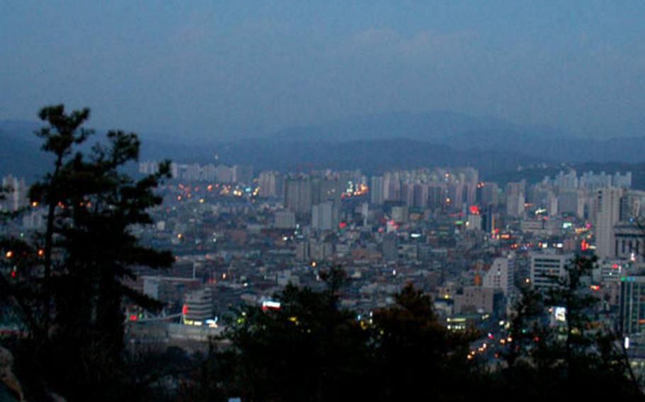 A full moon rising over Uijongbu, as seen from Bukhansan National Park.