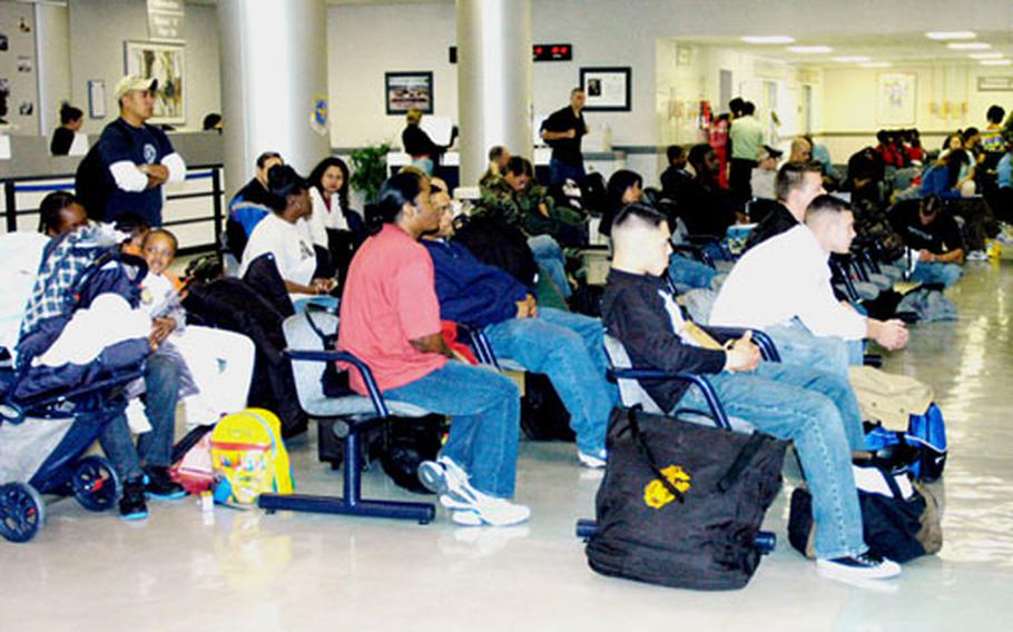 Travelers at Kadena AFB, Okinawa wait for their flight to depart. Officials at the 733rd Air Mobility Squadron passenger terminal at Kadena Air Base ask travelers to be patient and prepare for unexpected delays.