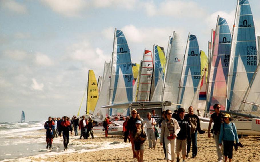 Spectators and crew members stroll past boats waiting to begin last year&#39;s Ronde om Texel race.