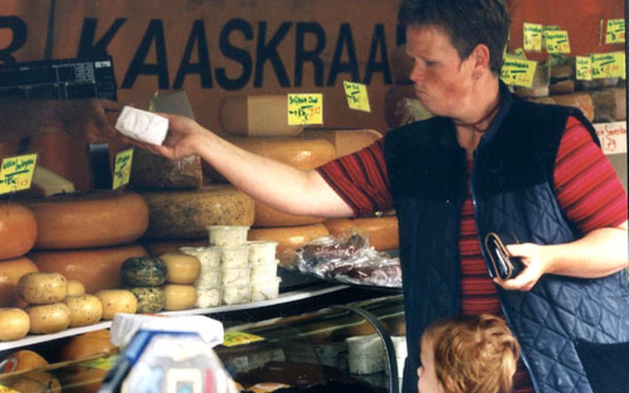 A local resident selects some cheese at the Monday market in Den Burg.