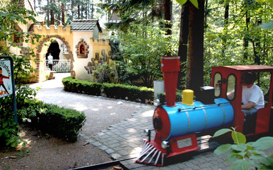 A small train chugs through the park, passing Rumplestiltskin&#39;s castle at Märchen Paradies on the Königstuhl in Heidelberg.
