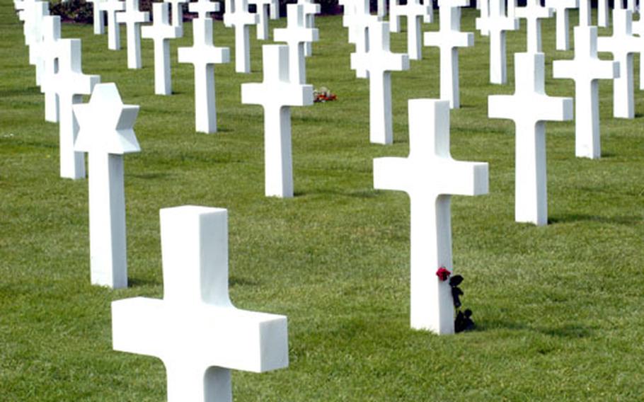 A lone rose pays final tribute to a fallen soldier at the Normandy American Cemetery in St. Laurent, France.