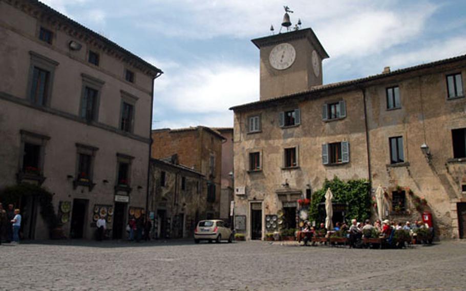 Visitors enjoy lunch in the piazza near the main cathedral in Orvieto, Italy. The medieval town has scores of shops and restaurants.