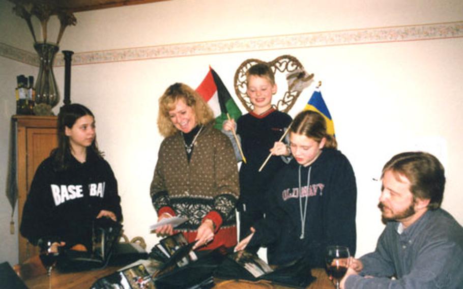 The McDonald family with their nine travel scrapbooks and souvenirs, from left: Casey, 12; mother Jeanne; Brody, 8; Brooke, 11; and father Kevin. Brody has collected flags from each country the family has visited.